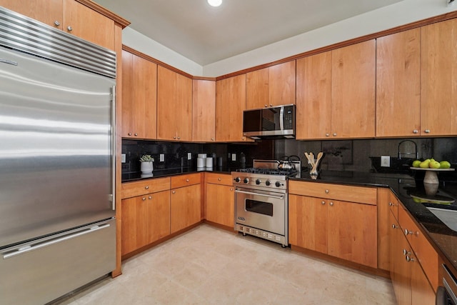 7400 River Rd Unit 114, North Bergen, NJ 07047 - kitchen with high end appliances, tasteful backsplash, and brown cabinets