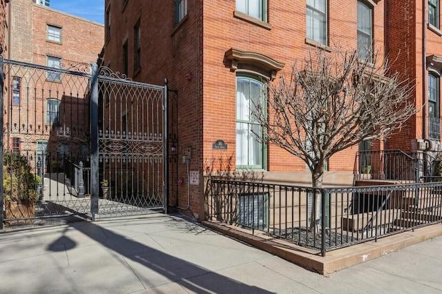 view of gate with a fenced front yard