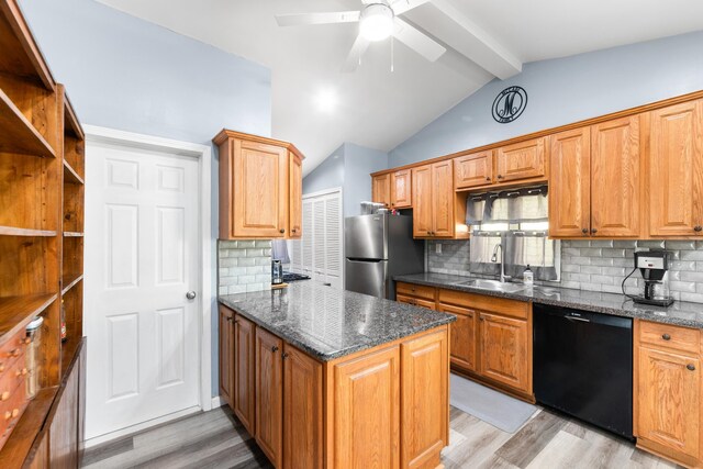 kitchen featuring freestanding refrigerator, vaulted ceiling with beams, a sink, light wood-style flooring, and dishwasher