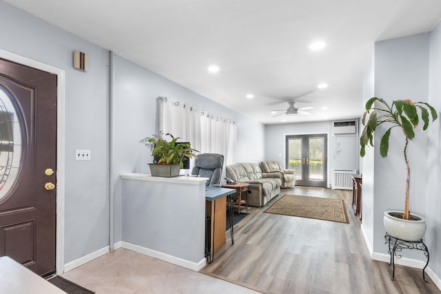 foyer entrance featuring radiator, baseboards, ceiling fan, recessed lighting, and a wall unit AC