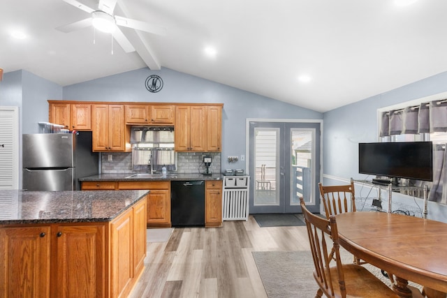 kitchen with light wood-type flooring, a sink, freestanding refrigerator, lofted ceiling with beams, and black dishwasher