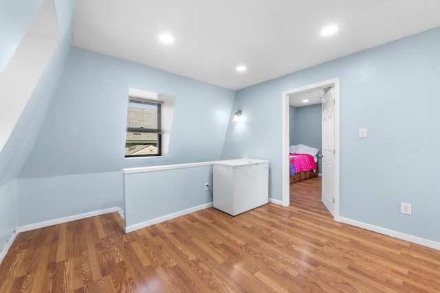bonus room with recessed lighting, baseboards, and wood finished floors