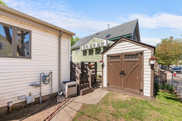 view of shed featuring fence