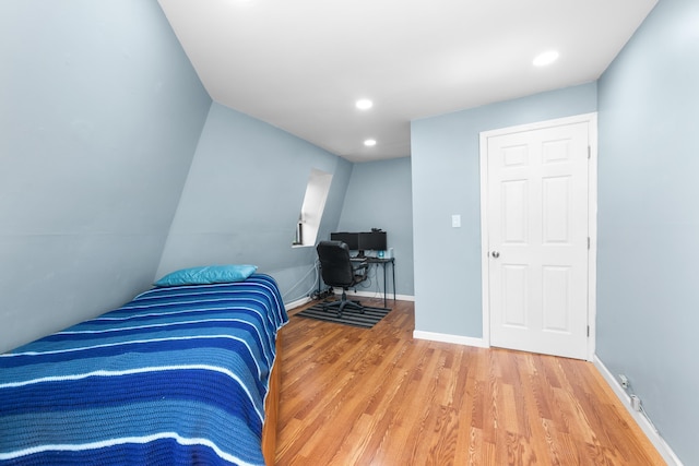 bedroom with recessed lighting, baseboards, and wood finished floors