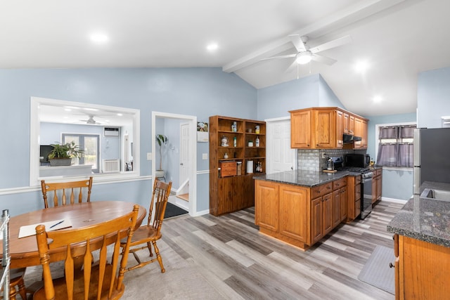 kitchen featuring ceiling fan, light wood finished floors, stainless steel appliances, under cabinet range hood, and vaulted ceiling
