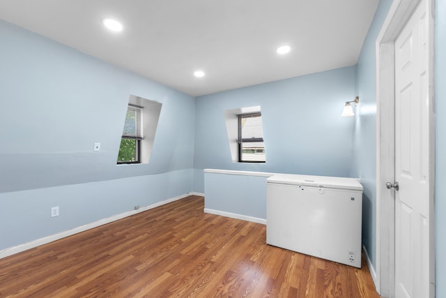 unfurnished room featuring recessed lighting, baseboards, and wood finished floors