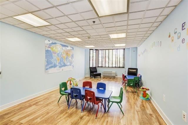game room with baseboards and wood finished floors