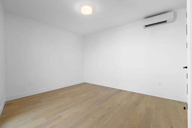 391 1st St Unit 4-C, Jersey City, NJ 07302 - spare room featuring a wall mounted AC and light wood-style floors