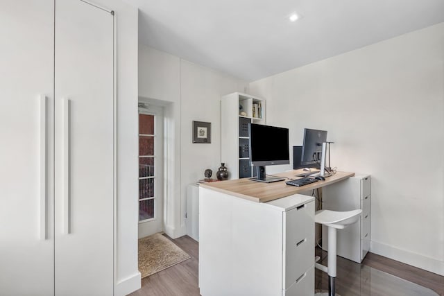 home office featuring light wood-type flooring and baseboards