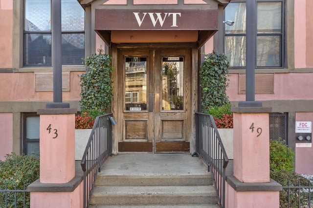 property entrance featuring stucco siding