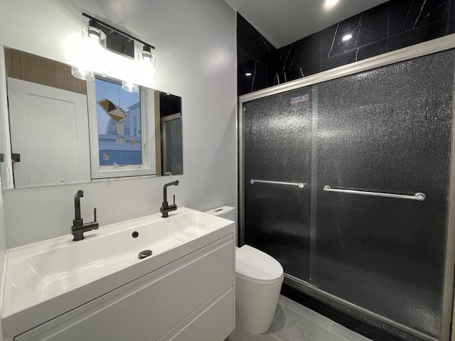 bathroom with vanity, toilet, and a shower stall