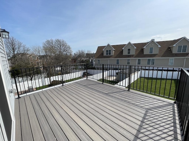 deck featuring a lawn and a residential view
