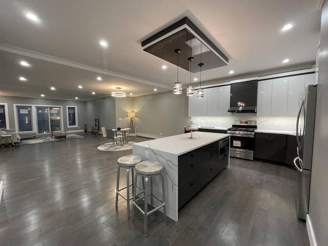 kitchen with a center island, stainless steel appliances, modern cabinets, and dark wood-type flooring