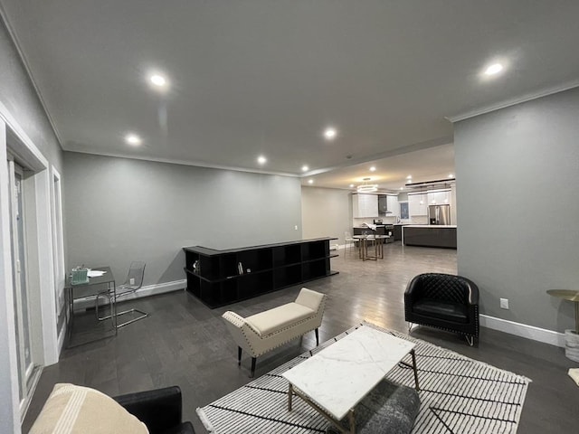 living room with dark wood finished floors, baseboards, ornamental molding, and recessed lighting