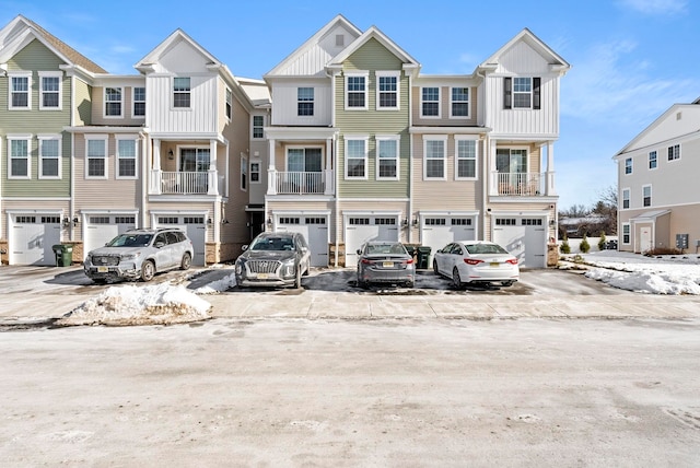 view of front facade with an attached garage, driveway, and board and batten siding