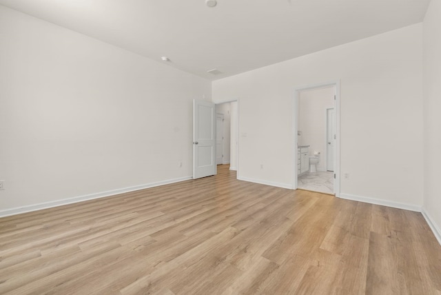 unfurnished room with light wood-style floors and baseboards