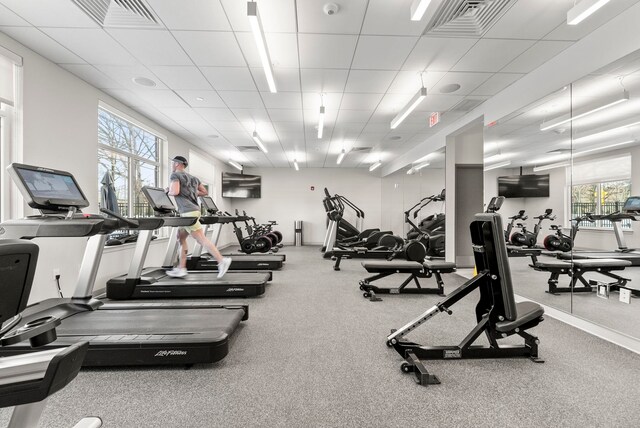 exercise room with a paneled ceiling
