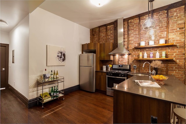 kitchen with stainless steel appliances, dark wood-type flooring, kitchen peninsula, sink, and wall chimney range hood