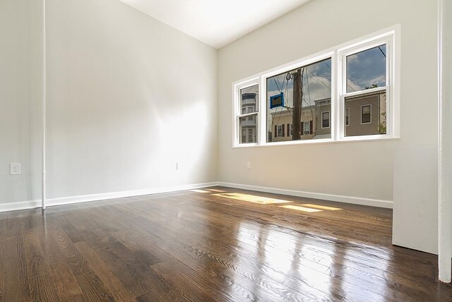 spare room featuring dark hardwood / wood-style flooring