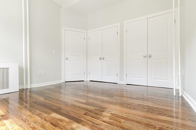 unfurnished bedroom featuring hardwood / wood-style flooring