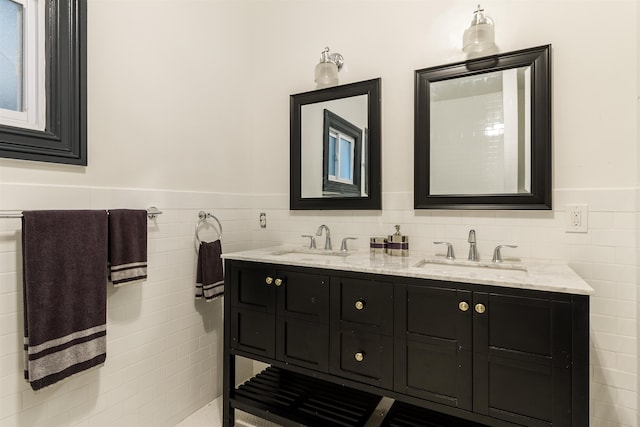 bathroom with vanity and tile walls