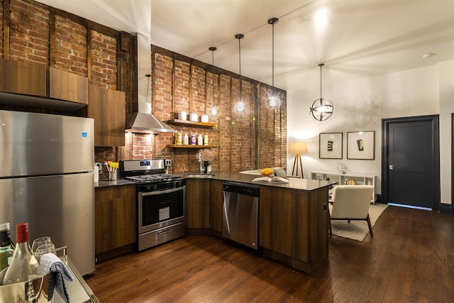 kitchen with dark wood-type flooring, kitchen peninsula, appliances with stainless steel finishes, and sink