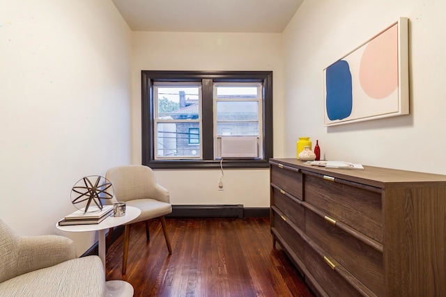 living area featuring dark wood-type flooring and a baseboard radiator