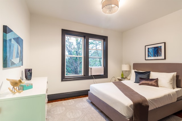 bedroom featuring a baseboard radiator and light hardwood / wood-style flooring