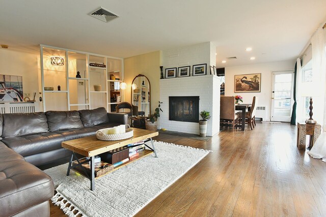 87 Stony Ridge Dr, Hillsdale, NJ 07642 - living area featuring a fireplace, wood finished floors, radiator, visible vents, and recessed lighting