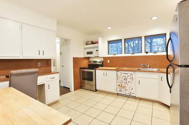 87 Stony Ridge Dr, Hillsdale, NJ 07642 - kitchen featuring light tile patterned flooring, white cabinetry, a sink, and appliances with stainless steel finishes