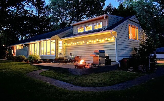 87 Stony Ridge Dr, Hillsdale, NJ 07642 - back of property with a patio, a sunroom, an outdoor fire pit, and a yard