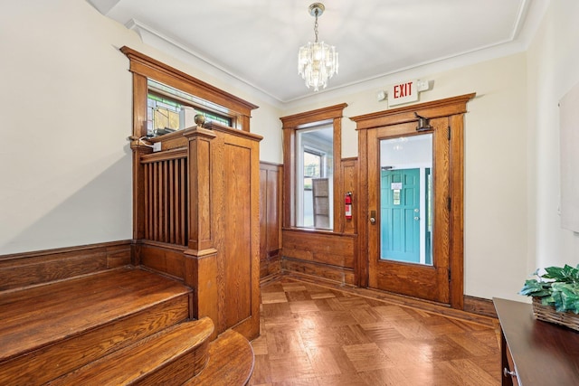 5 77th St, North Bergen, NJ 07047 - entrance foyer featuring a chandelier, a wainscoted wall, and crown molding