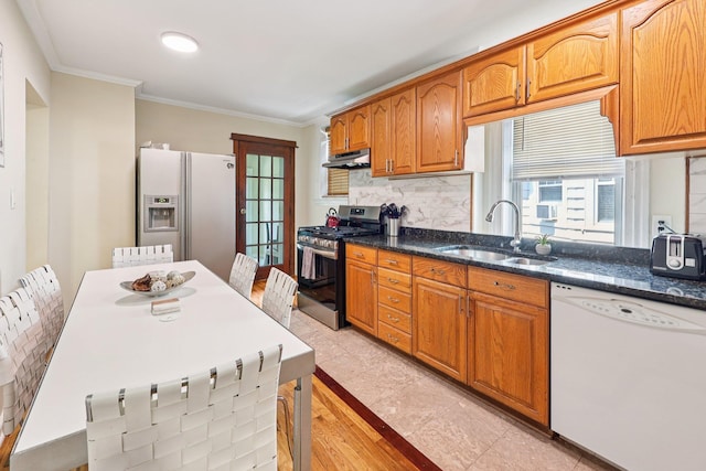 5 77th St, North Bergen, NJ 07047 - kitchen with white appliances, under cabinet range hood, decorative backsplash, ornamental molding, and brown cabinets