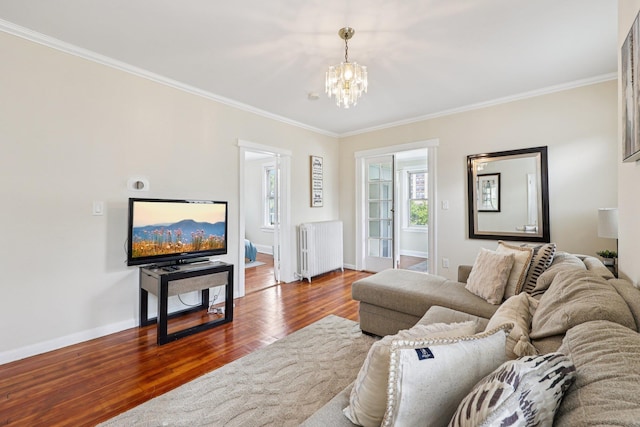 5 77th St, North Bergen, NJ 07047 - living room with radiator, crown molding, wood finished floors, and a chandelier
