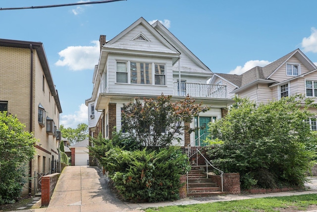 5 77th St, North Bergen, NJ 07047 - view of front facade with a balcony, stairway, and a chimney