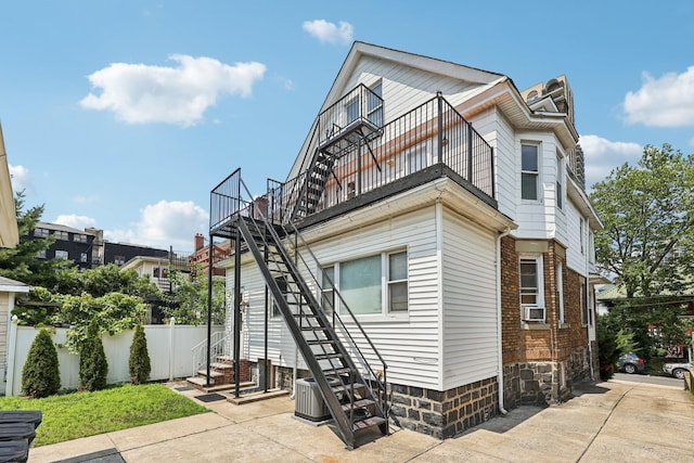 5 77th St, North Bergen, NJ 07047 - view of front of house with stairway, a balcony, and cooling unit