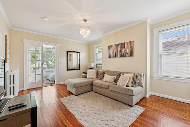 5 77th St, North Bergen, NJ 07047 - living room with hardwood / wood-style flooring, ornamental molding, a chandelier, and radiator heating unit