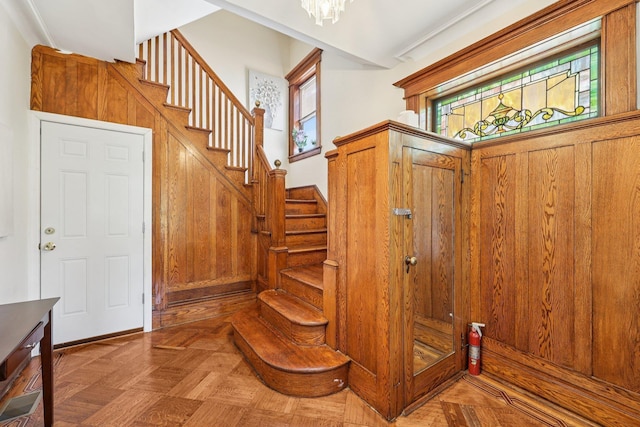 5 77th St, North Bergen, NJ 07047 - stairway with a chandelier and wooden walls