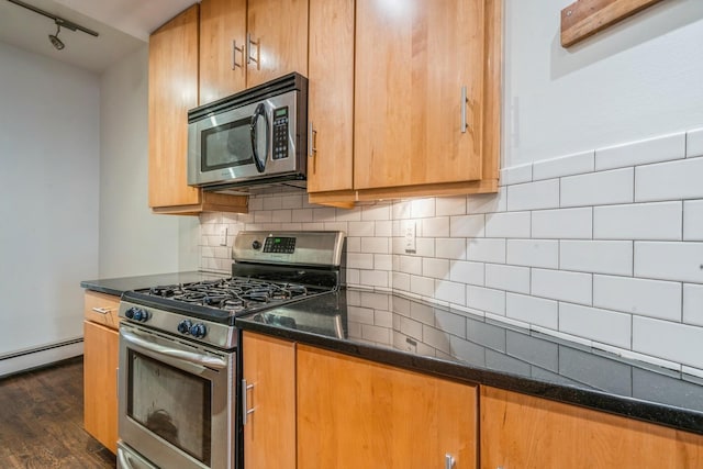 297 Pavonia Ave Unit 2A, Jersey City, NJ 07302 - kitchen with stainless steel appliances, dark wood-style flooring, baseboard heating, and decorative backsplash