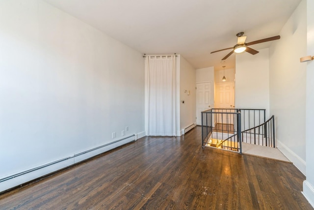 297 Pavonia Ave Unit 2A, Jersey City, NJ 07302 - spare room featuring baseboard heating, wood finished floors, a ceiling fan, and baseboards