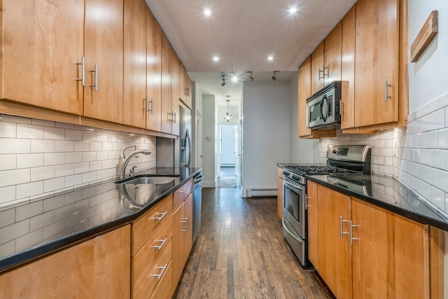 297 Pavonia Ave Unit 2A, Jersey City, NJ 07302 - kitchen featuring stainless steel appliances, a sink, a baseboard heating unit, dark wood-type flooring, and brown cabinets