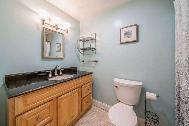 297 Pavonia Ave Unit 2A, Jersey City, NJ 07302 - bathroom with toilet, vanity, tile patterned flooring, and baseboards
