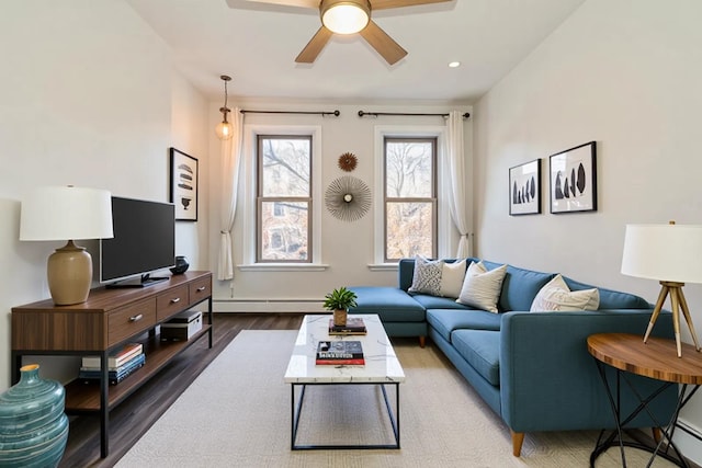 297 Pavonia Ave Unit 2A, Jersey City, NJ 07302 - living room with baseboard heating, wood finished floors, a ceiling fan, and baseboards