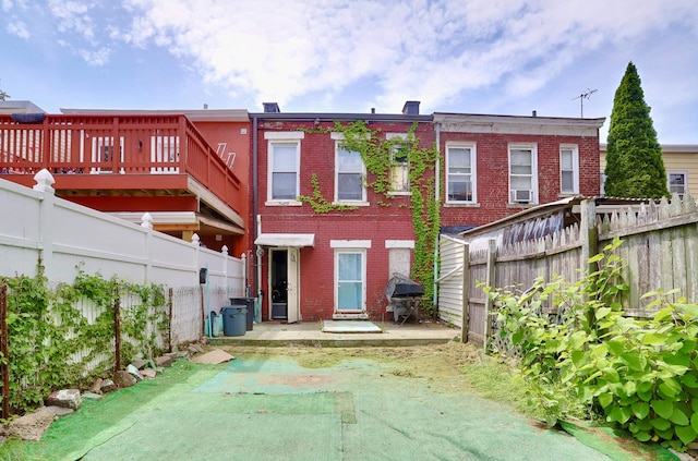 400 67th St, West New York, NJ 07093 - back of property with brick siding, a fenced backyard, and a patio area