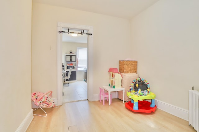 400 67th St, West New York, NJ 07093 - game room featuring radiator heating unit, wood finished floors, and baseboards