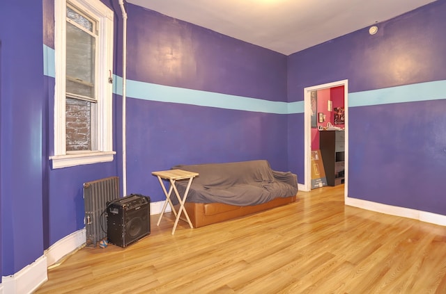 400 67th St, West New York, NJ 07093 - sitting room with radiator heating unit, wood finished floors, and baseboards