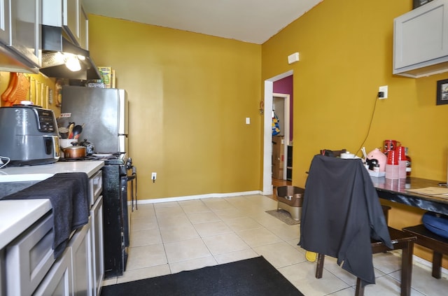400 67th St, West New York, NJ 07093 - kitchen featuring stove, freestanding refrigerator, and light tile patterned flooring