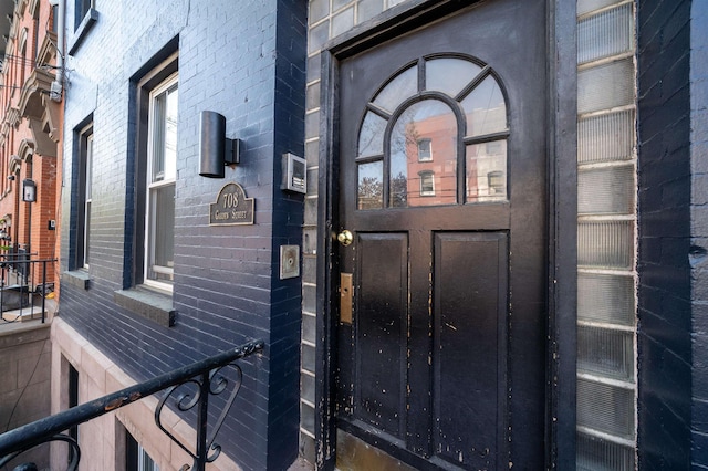 view of exterior entry with brick siding