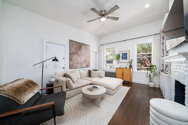 living area with a fireplace, baseboards, ceiling fan, recessed lighting, and dark wood finished floors