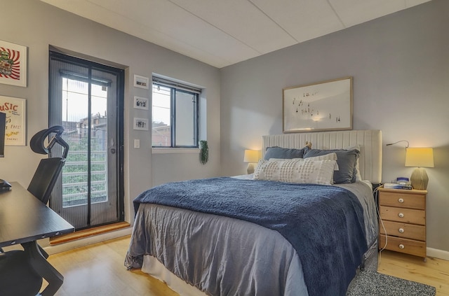 bedroom featuring wood finished floors and access to outside